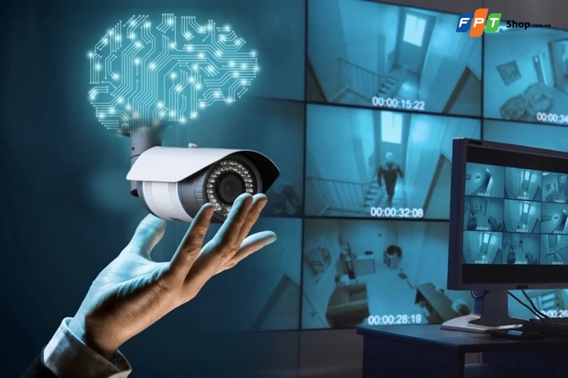 Minh họa camera giám sát cùng màn hình theo dõi nhiều khu vực và biểu tượng AI