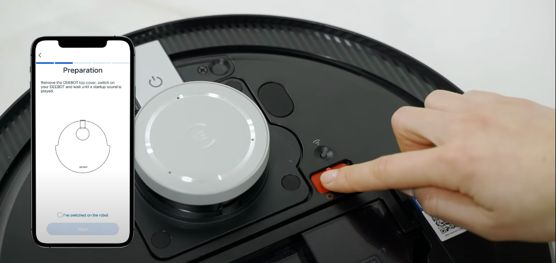 Nhấn nút đỏ trên thân máy robot hút bụi