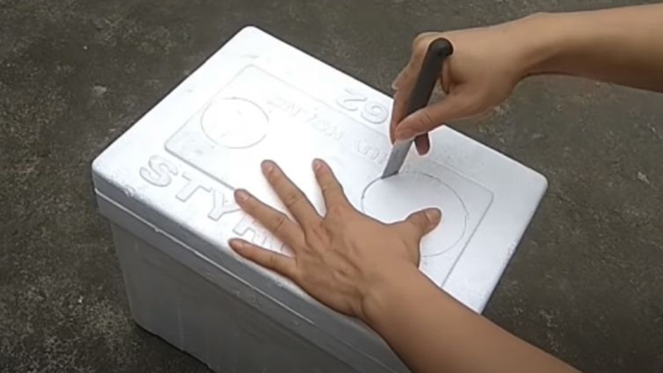 Dùng dao đục 2 lỗ trên thùng xốp