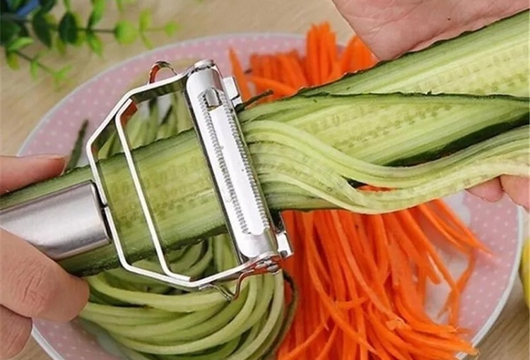 Julienned cucumbers and carrots in a white bowl
