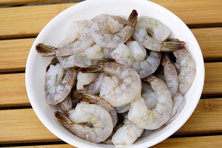 Sơ chế tôm bằng cách bỏ vỏ, râu, chân và chỉ sống lưng