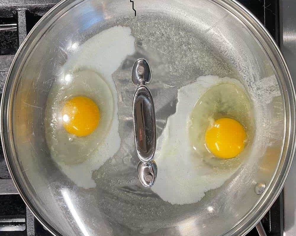 Đập nắp chảo chiên trứng để giúp giữ nhiệt, giúp trứng chín đều hơn